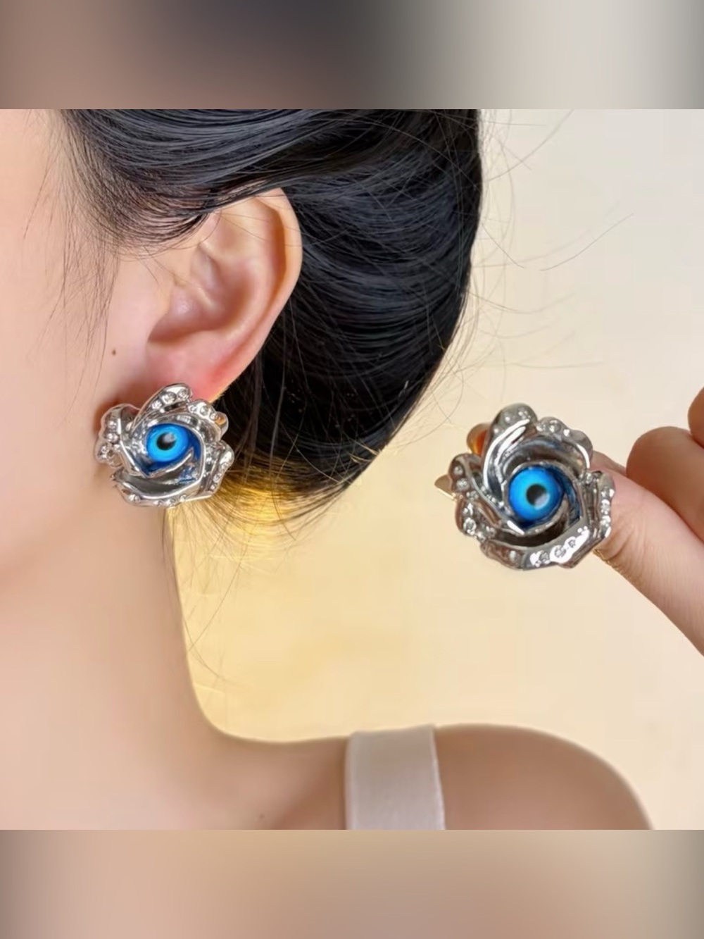 Schiaparelli Inspired Silver Floral Stud Earrings with Blue Evil Eye Accent